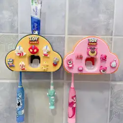 歯磨き粉のアーティファクトを絞る壁に取り付けられたパンチのない自動歯磨き粉スクイーザークリップをぶら下げている子供の漫画の歯ブラシラック