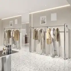 衣料品店の陳列だな壁に取り付けられたステンレス鋼の創造的なハンガーの簡単な棚の婦人服の店の陳列だな
